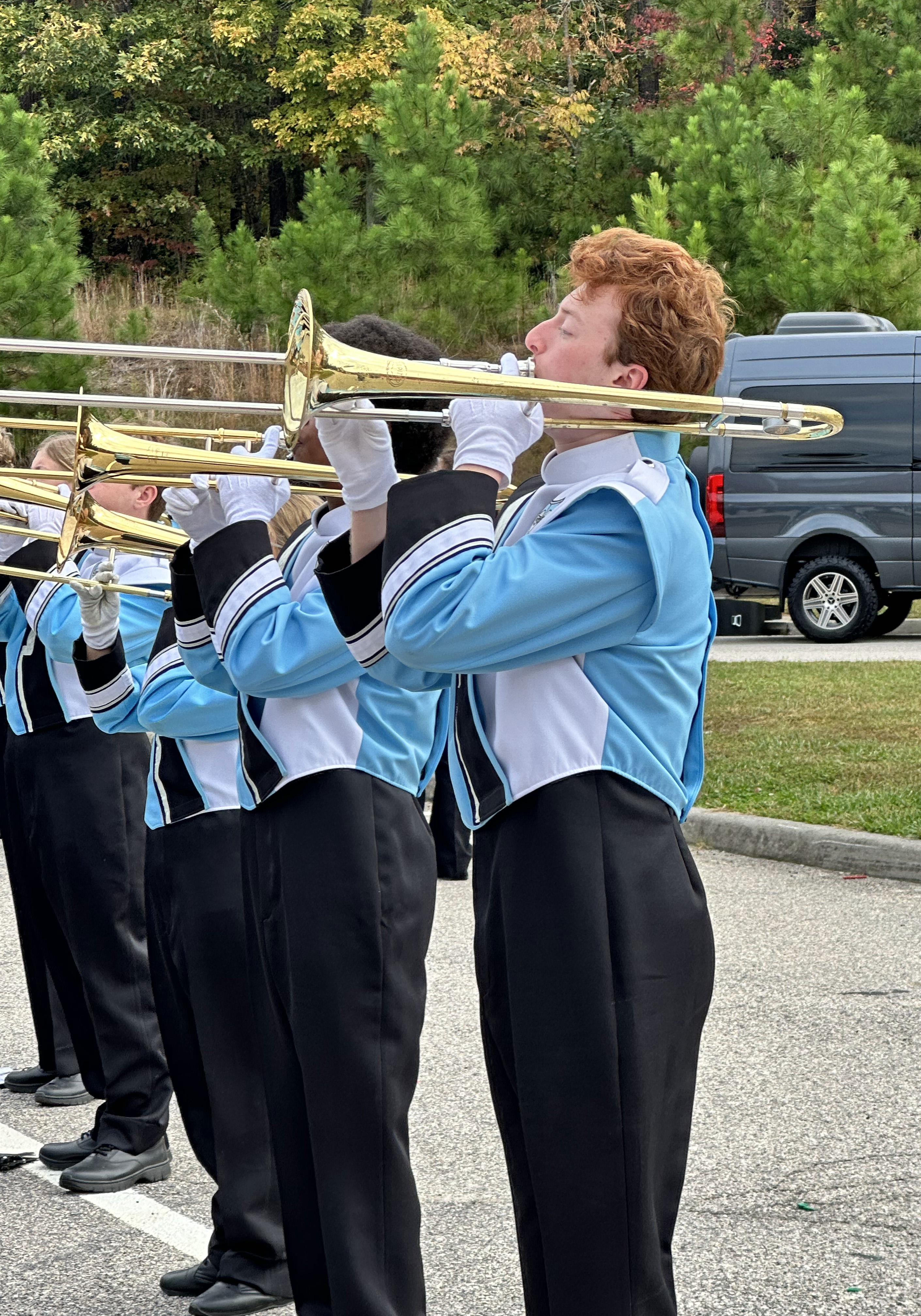 Students playing the trumpet outside