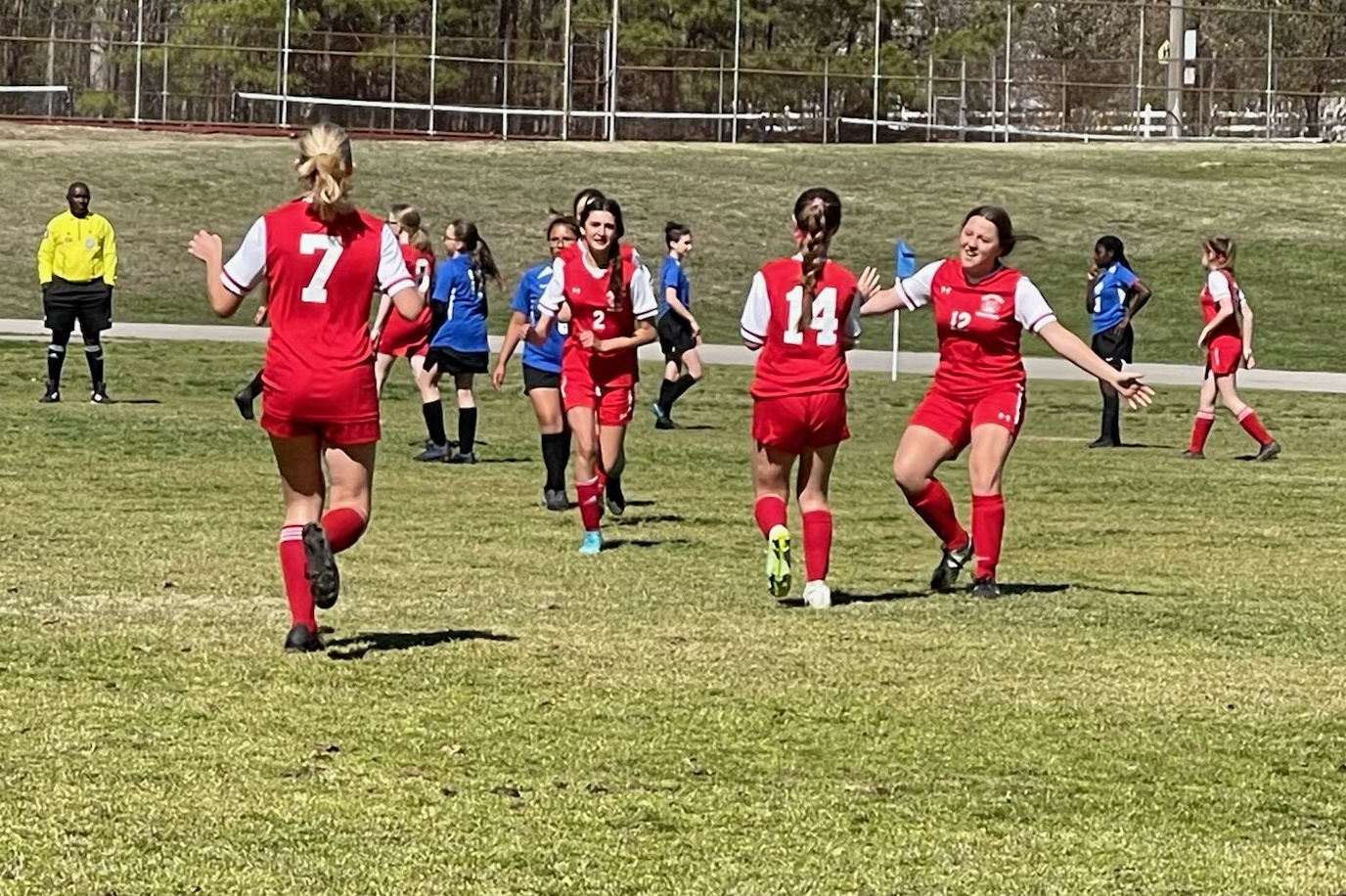 Girls soccer team congratulating each other