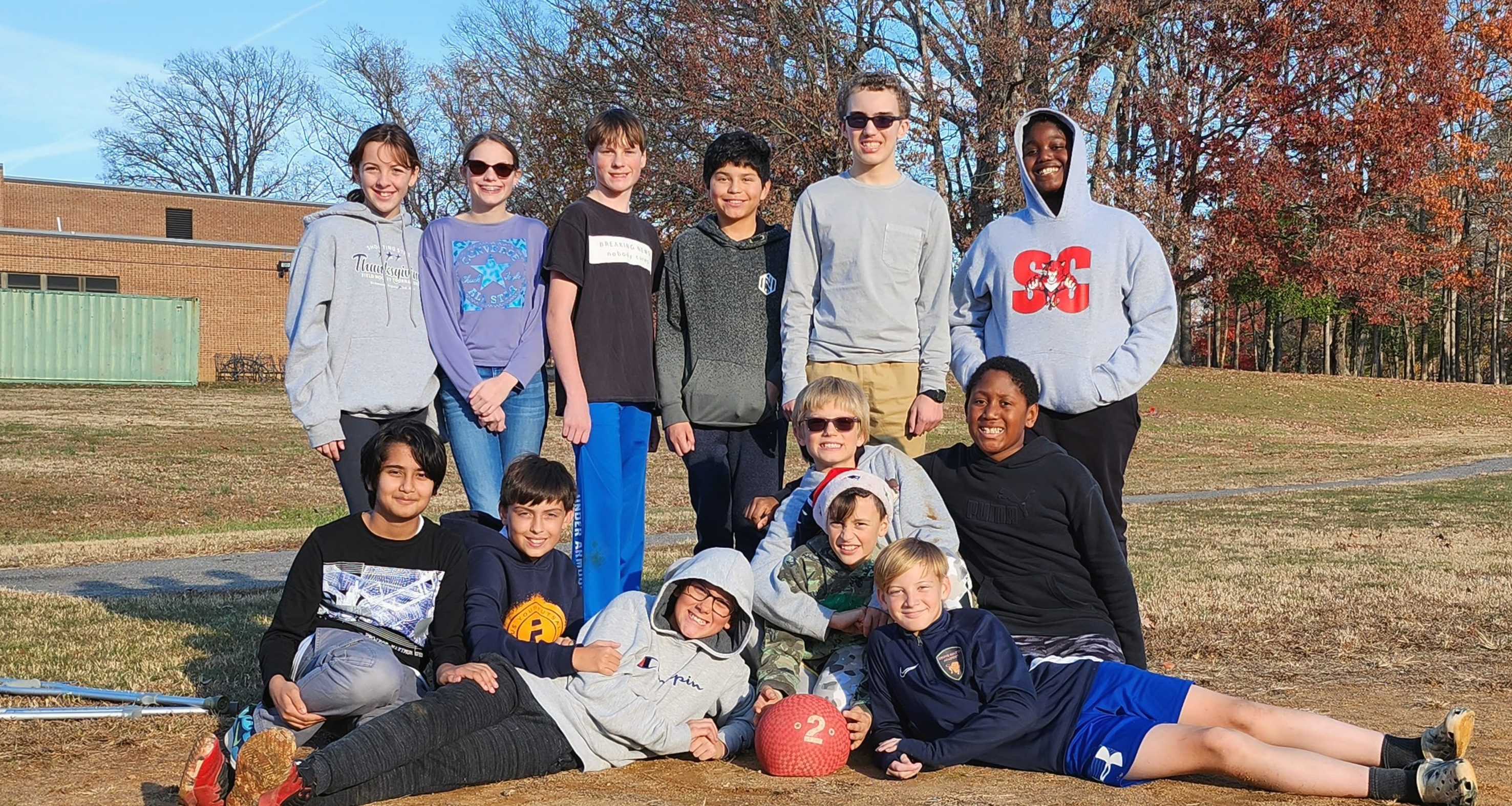 Students pose for a photo after playing kickball