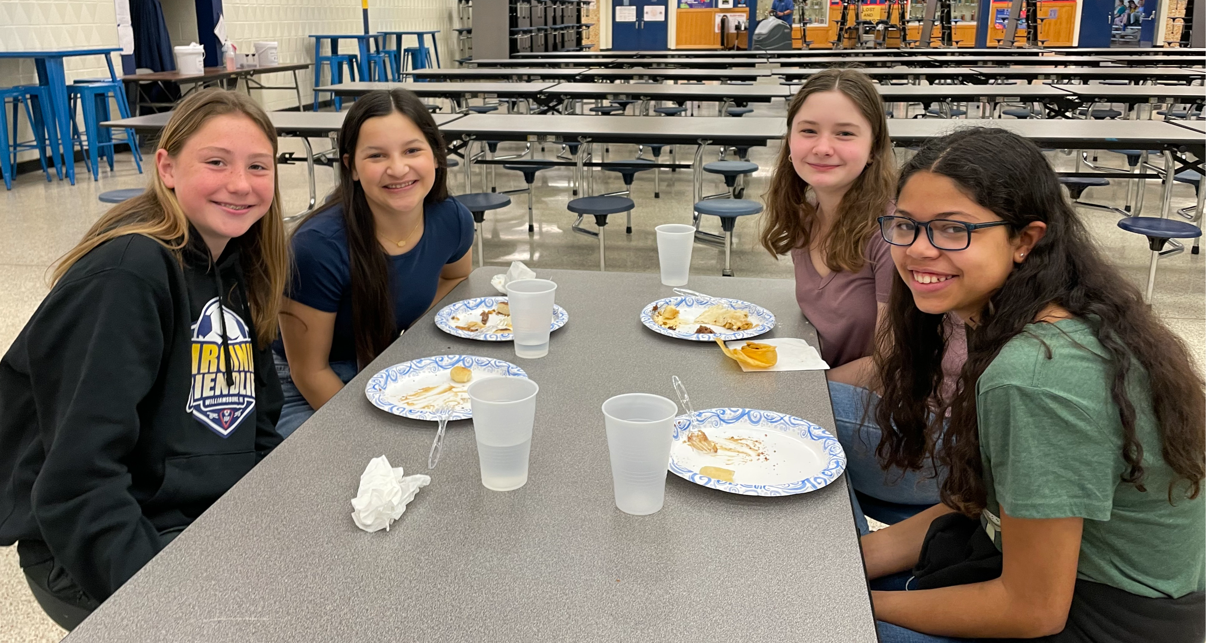Four girls eating in the school cafeteria