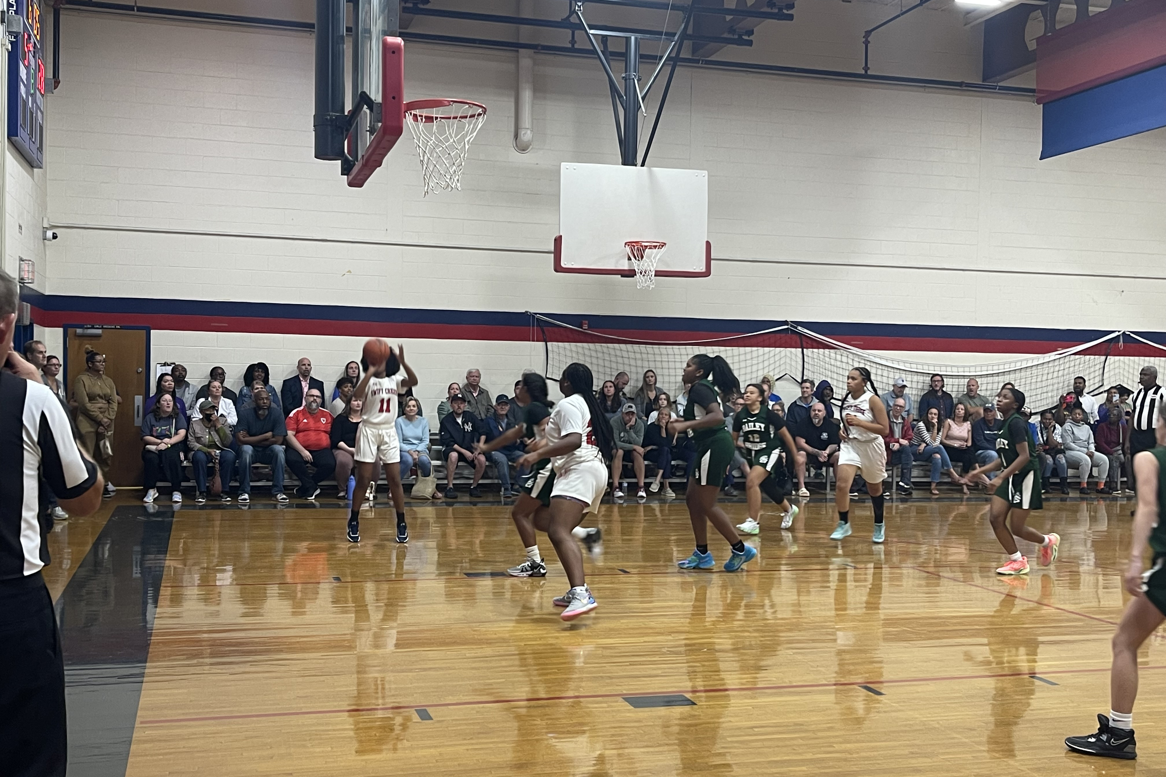 A girl shooting a basketball during a game