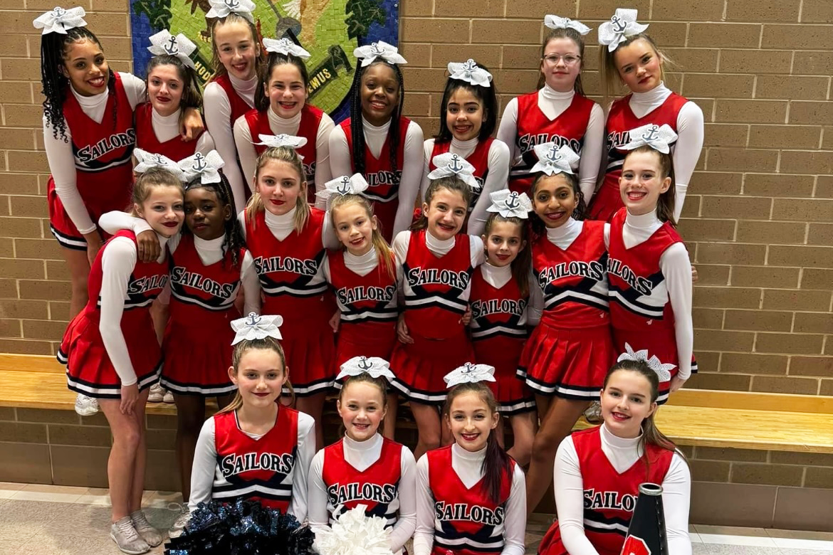 Cheerleading team photo in the school gymnasium