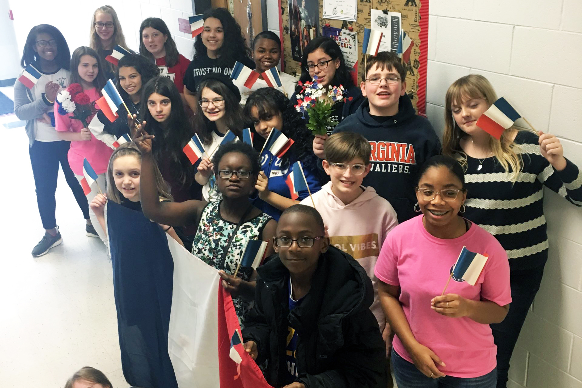 French Club members holding up small French flags
