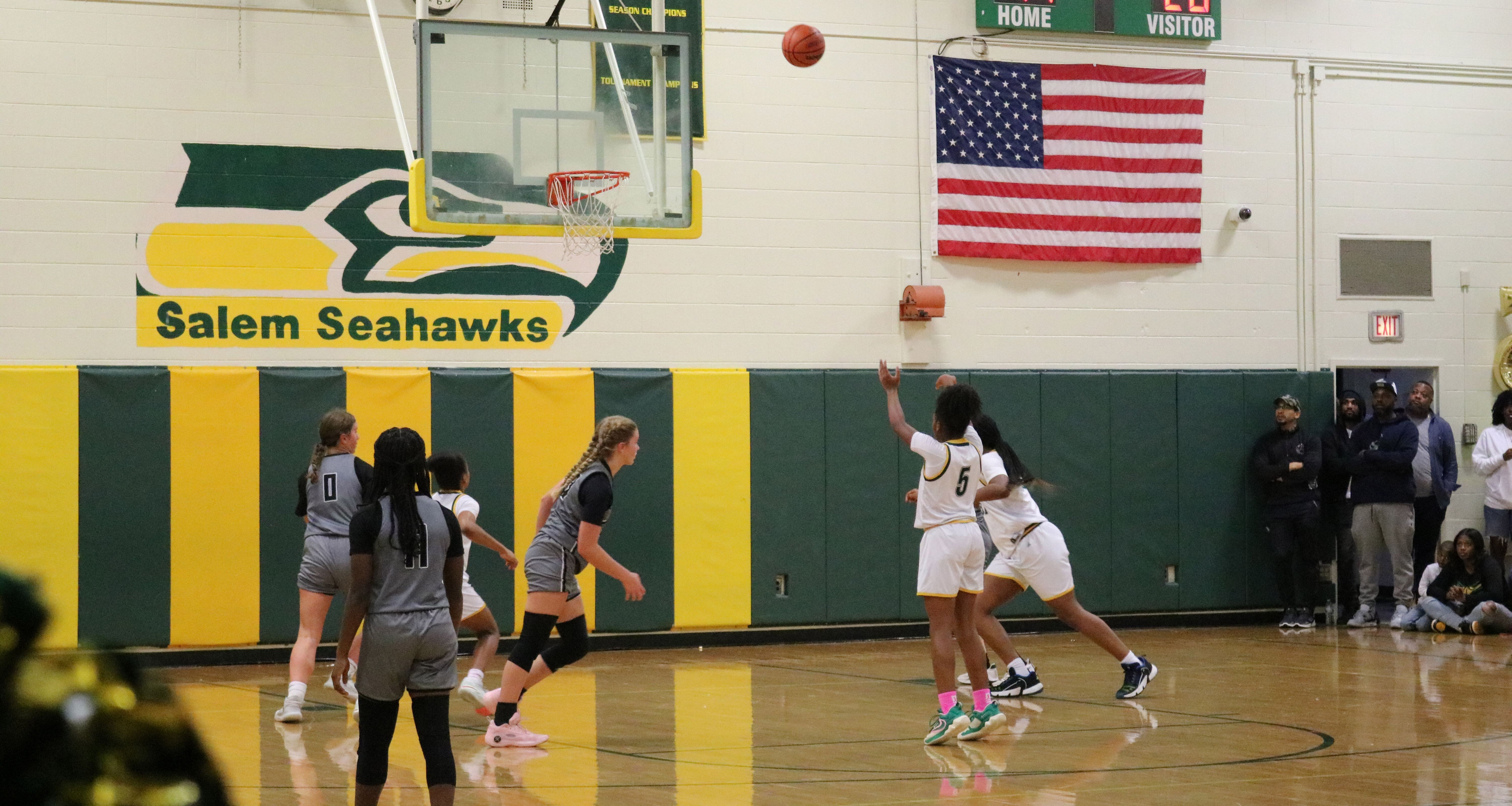 A girl shooting a basketball during a game
