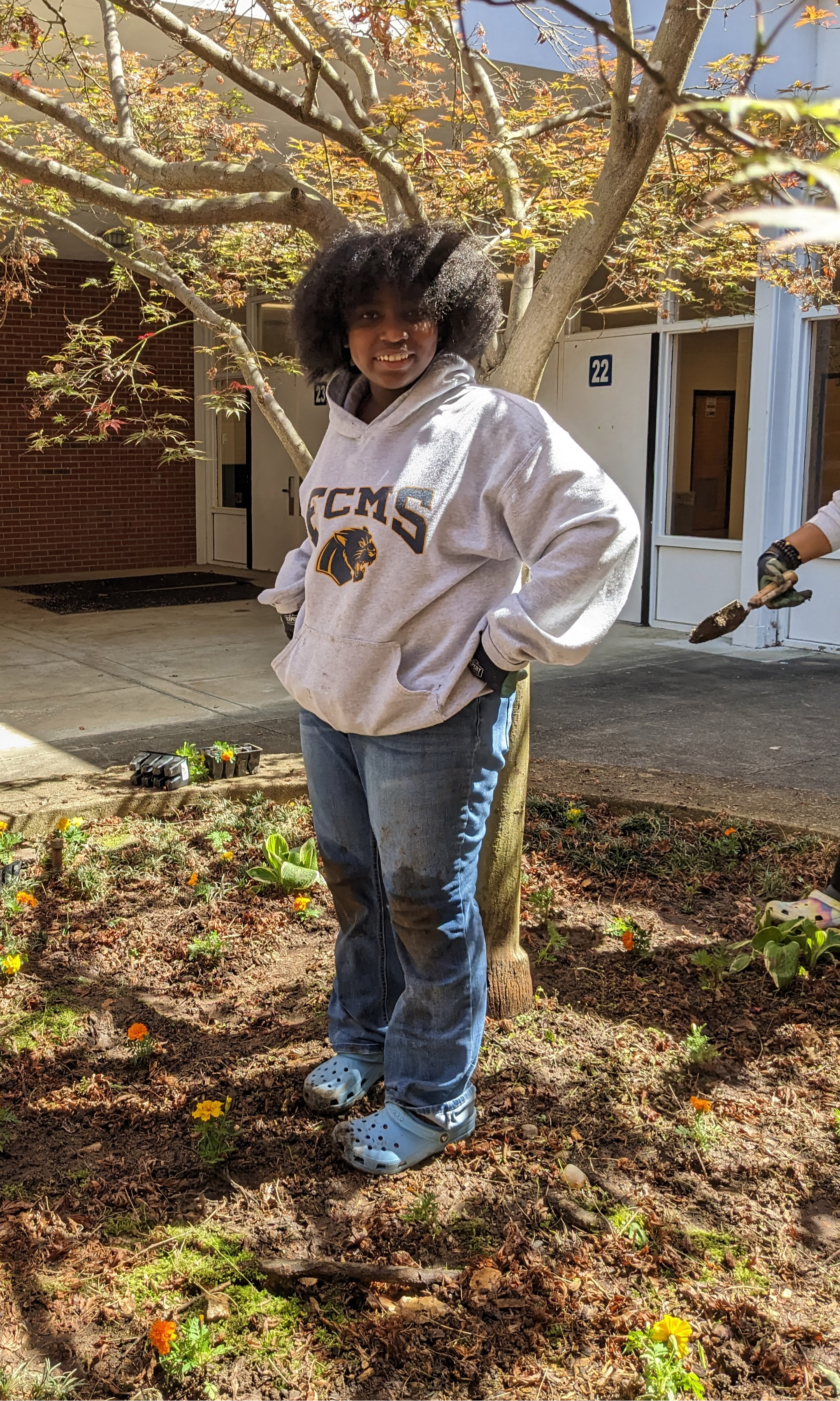 A student standing in front of a tree