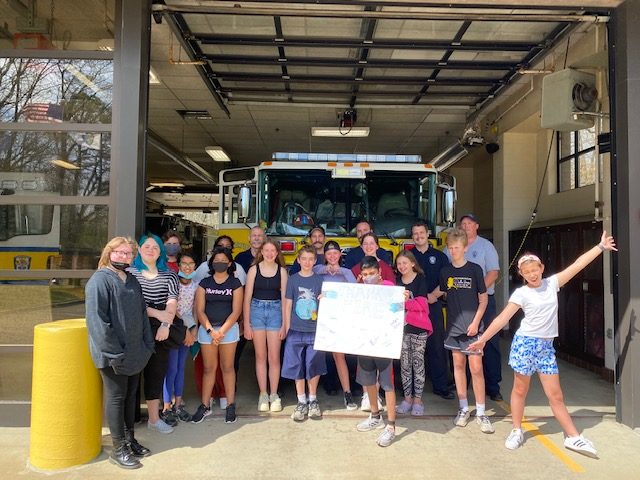 A group of students in front of a firetruck