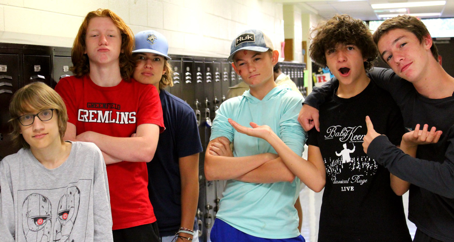 Six boys pose for a photo in the hallway