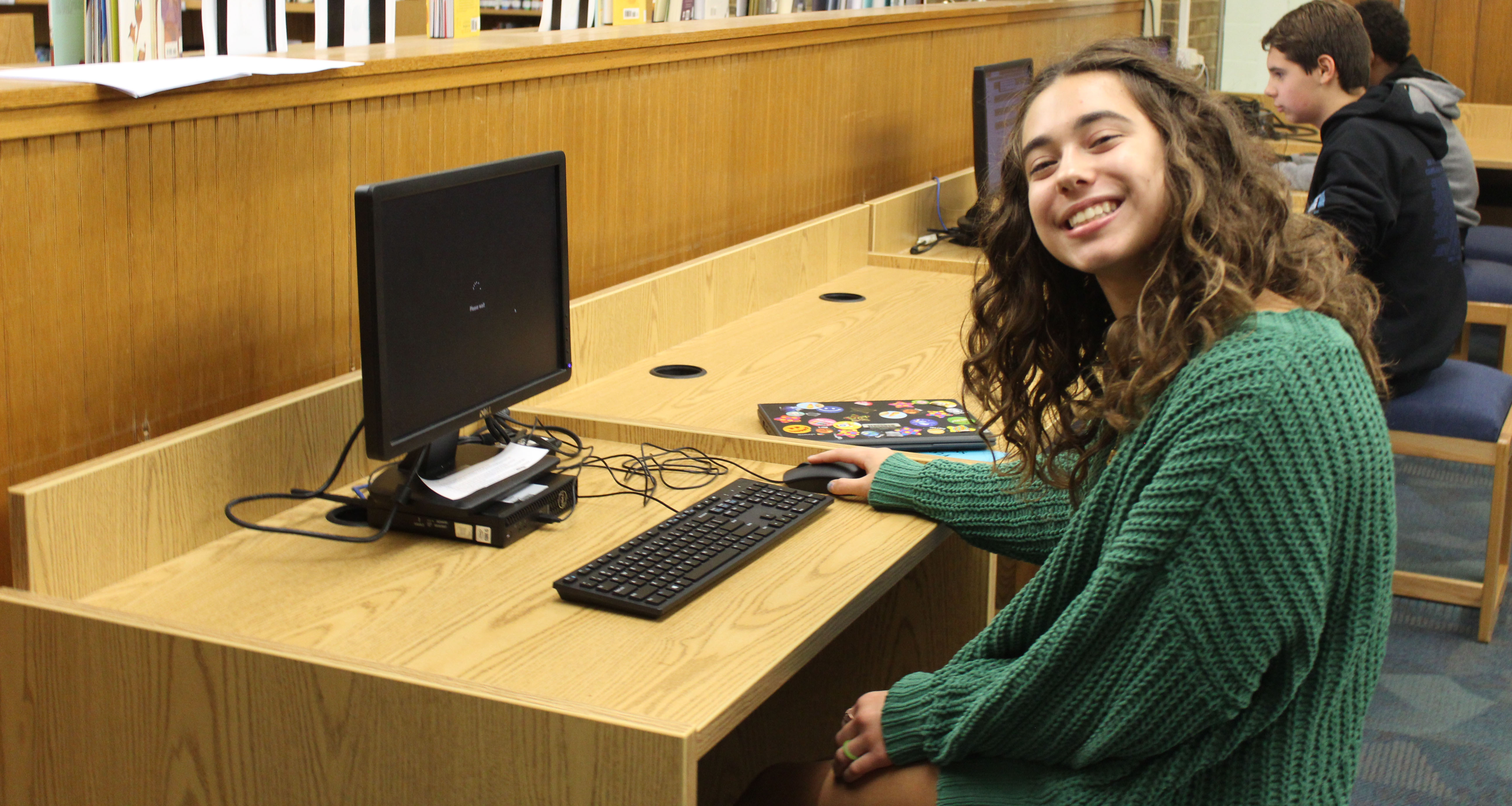 A student working on the computer in the school library