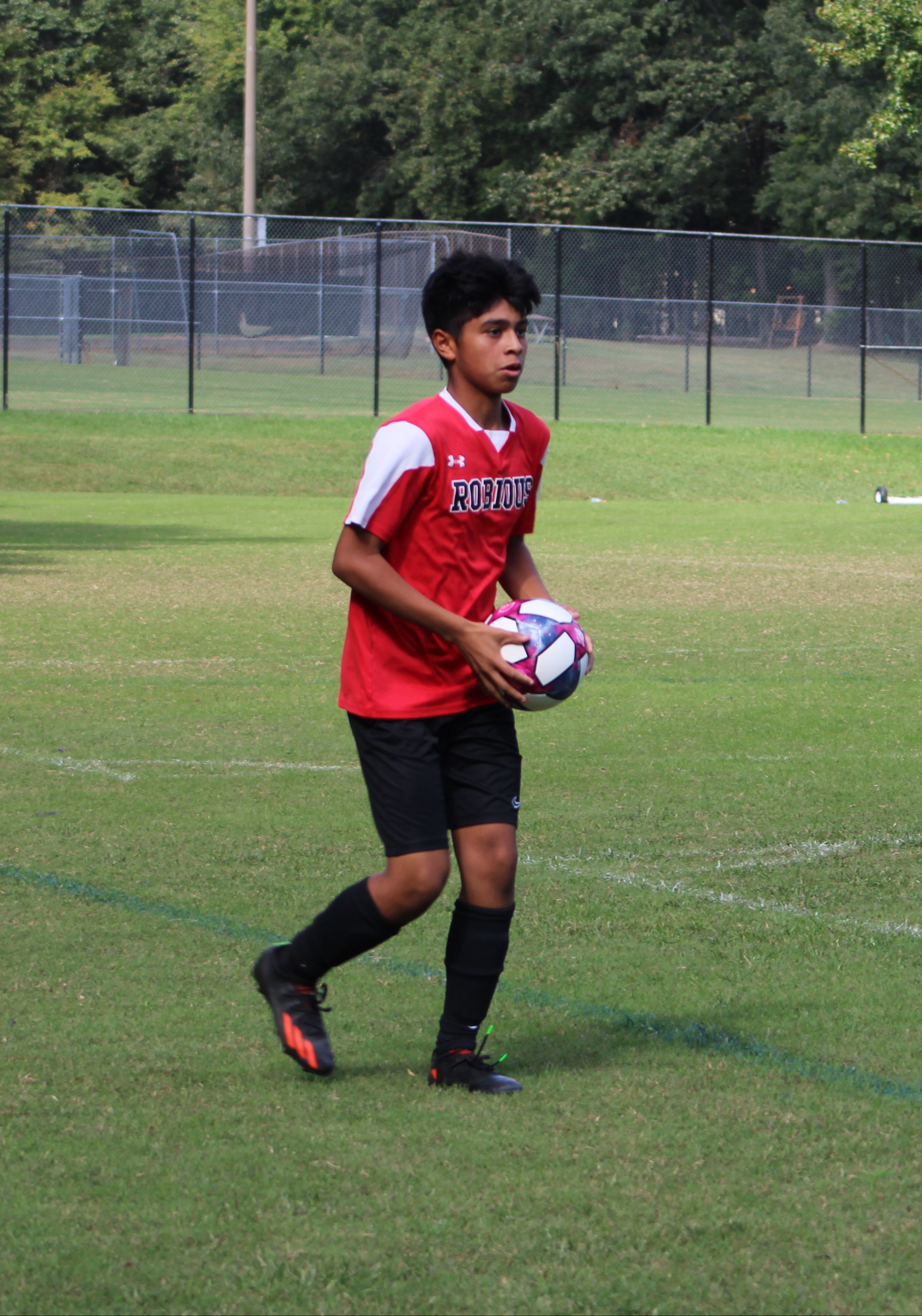 A student getting ready to throw a soccer ball