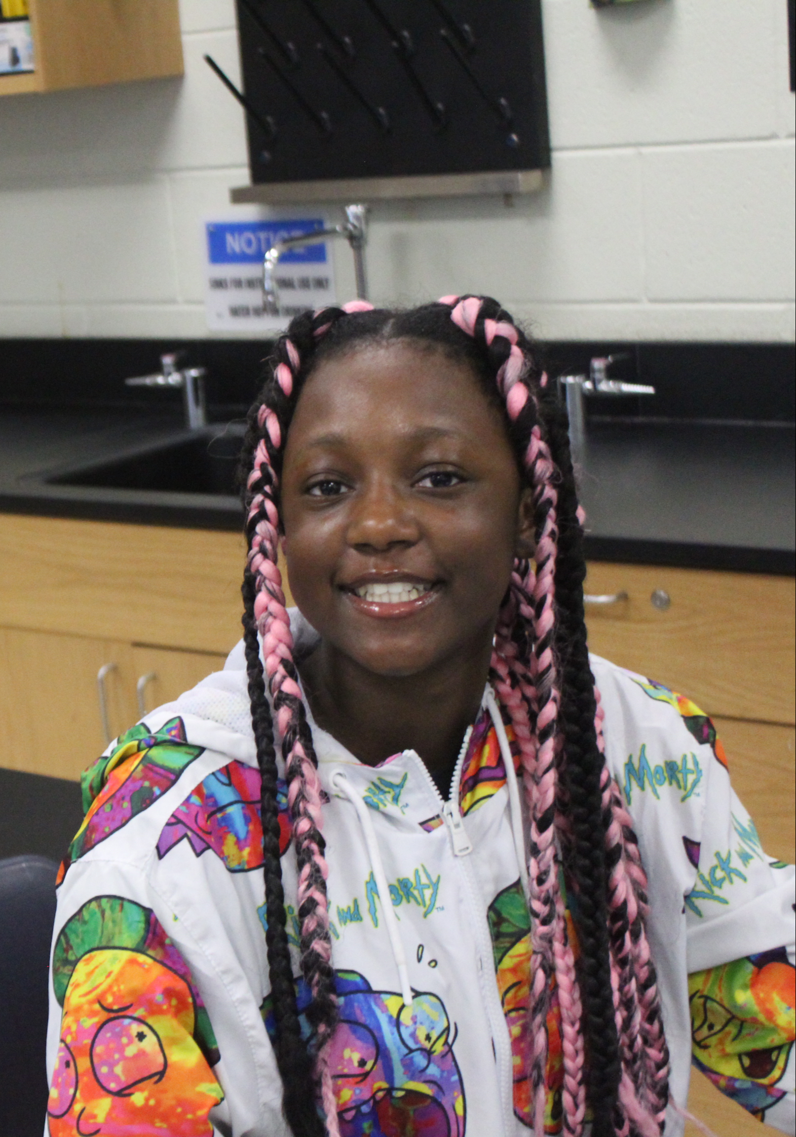 A student smiling in science class