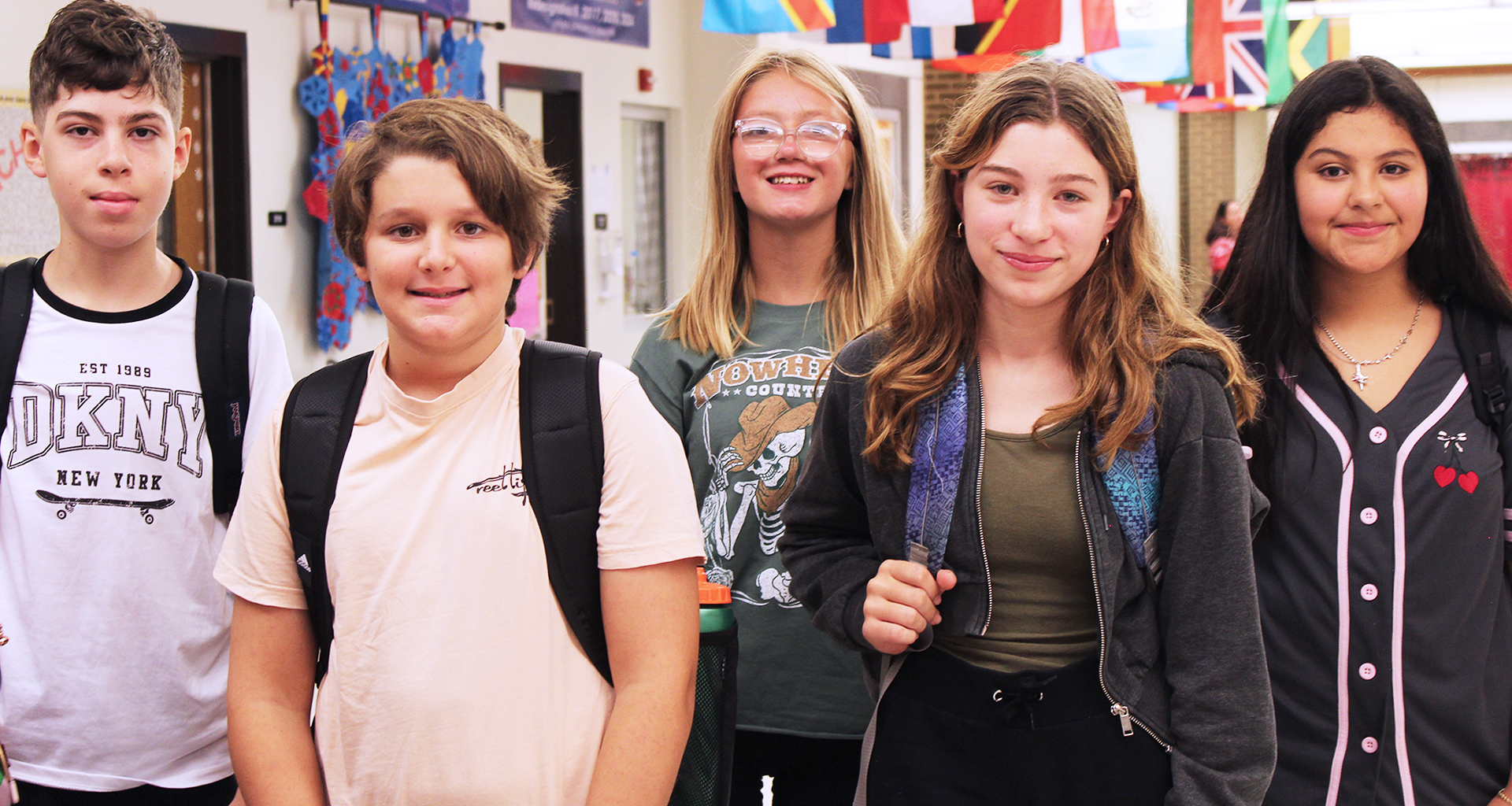 Seven students lined up against the lockers