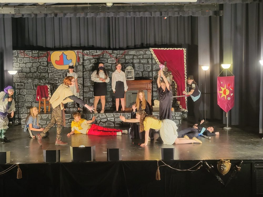 The drama club acting on stage
