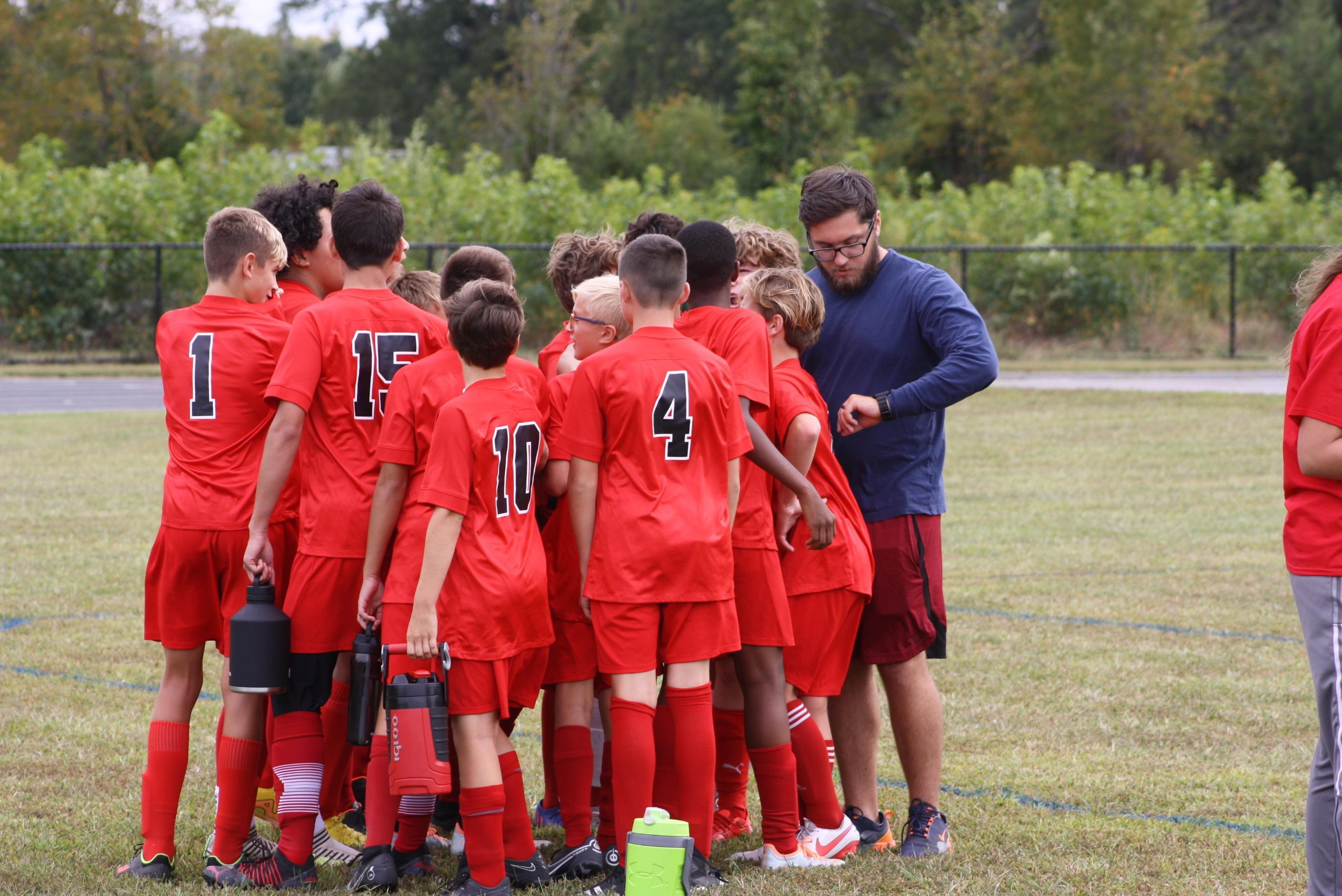 Boys soccer team receiving instructions from the coach