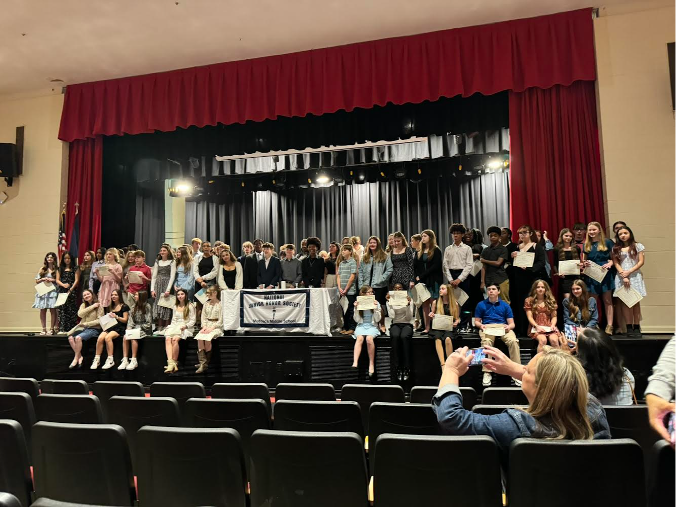 A group photo of the National Junior Honor Society on stage