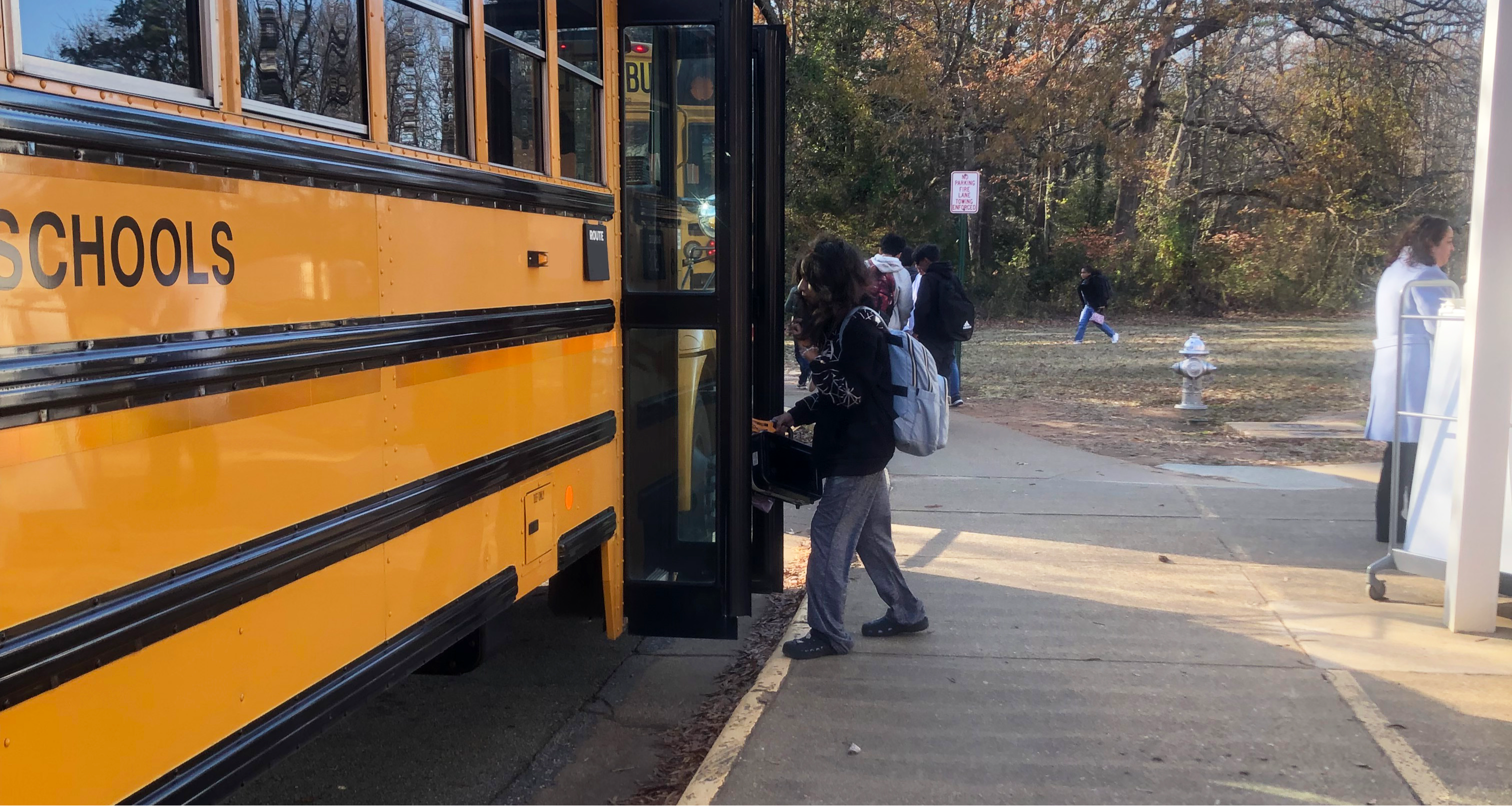 Students getting on school buses