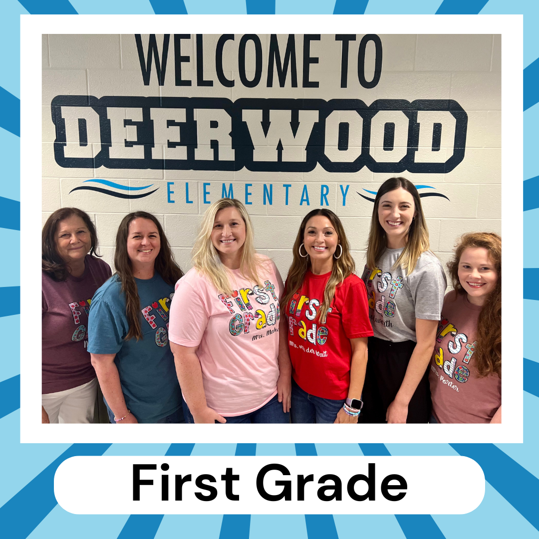 teachers standing posing in front of wall with graphic dolphin