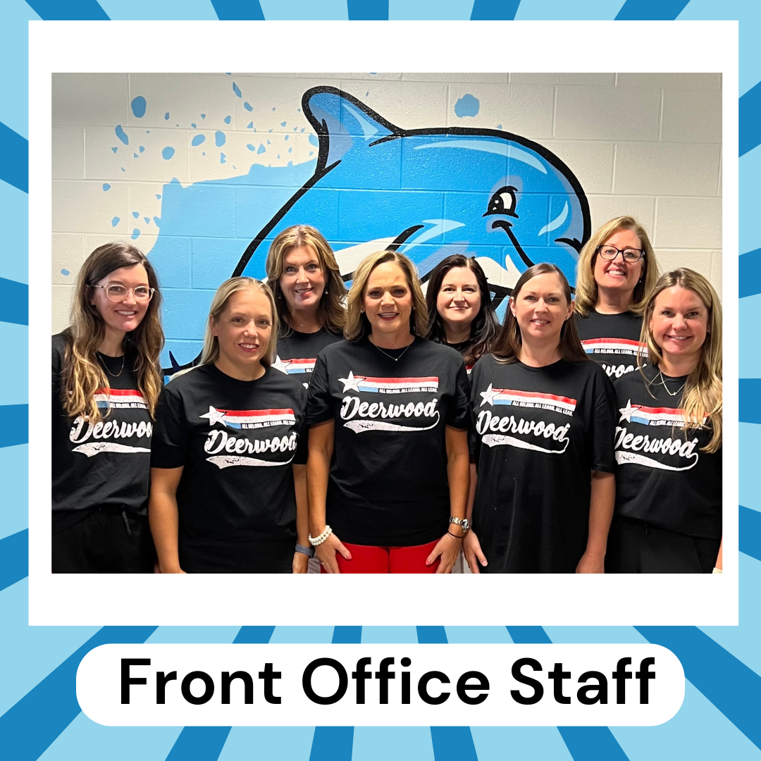 group of ladies in blue shirts in front of dolphin art