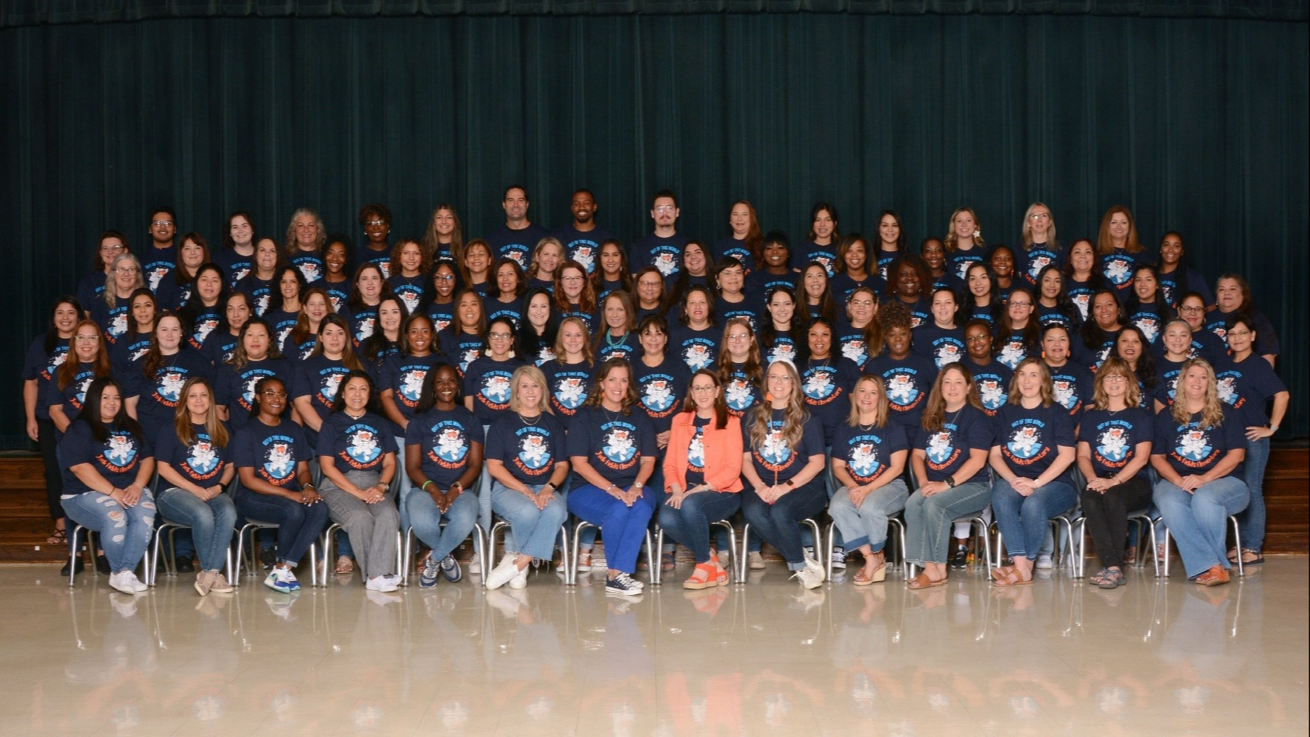 group of people posing in blue shirts