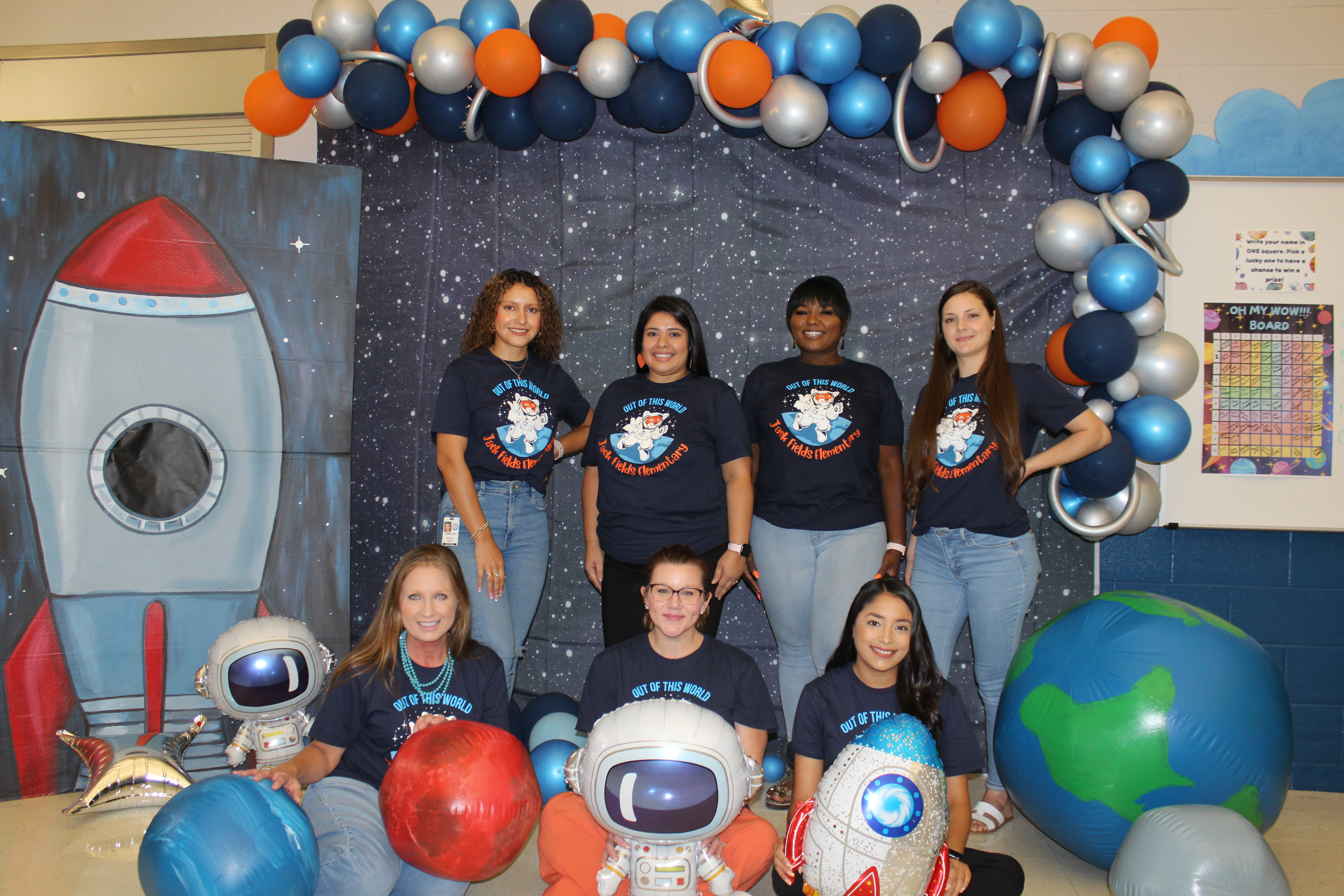 Third Grade teachers posing with space props