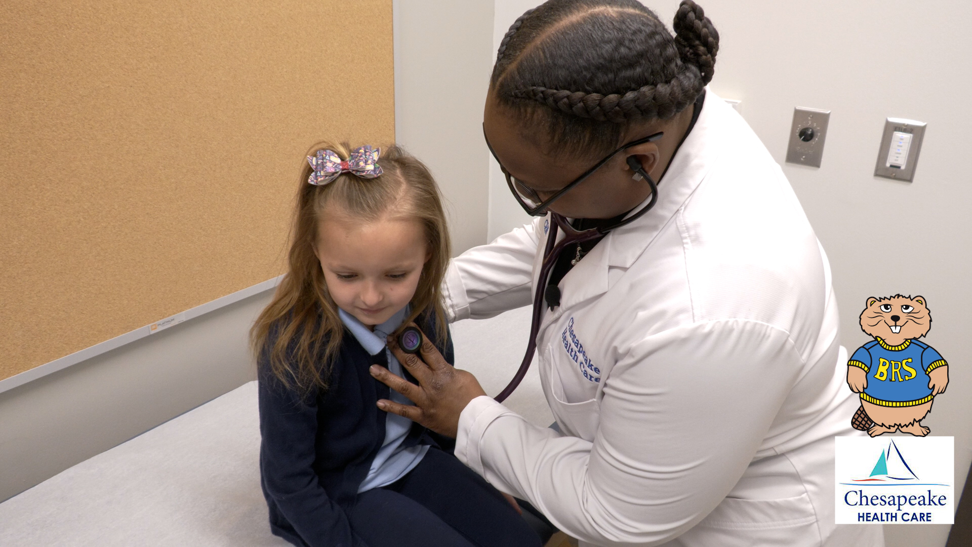 Image of a doctor listening to the hearbeat of a little girl 