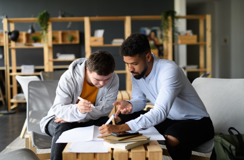 Image of young man with down syndrome working with Special Education teacher