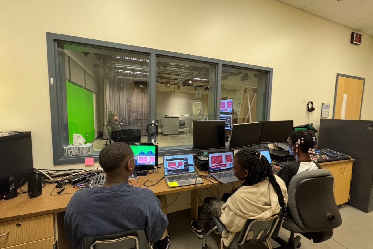 Image of students in a TV control room directing a news broadcast at Bennett Middle School