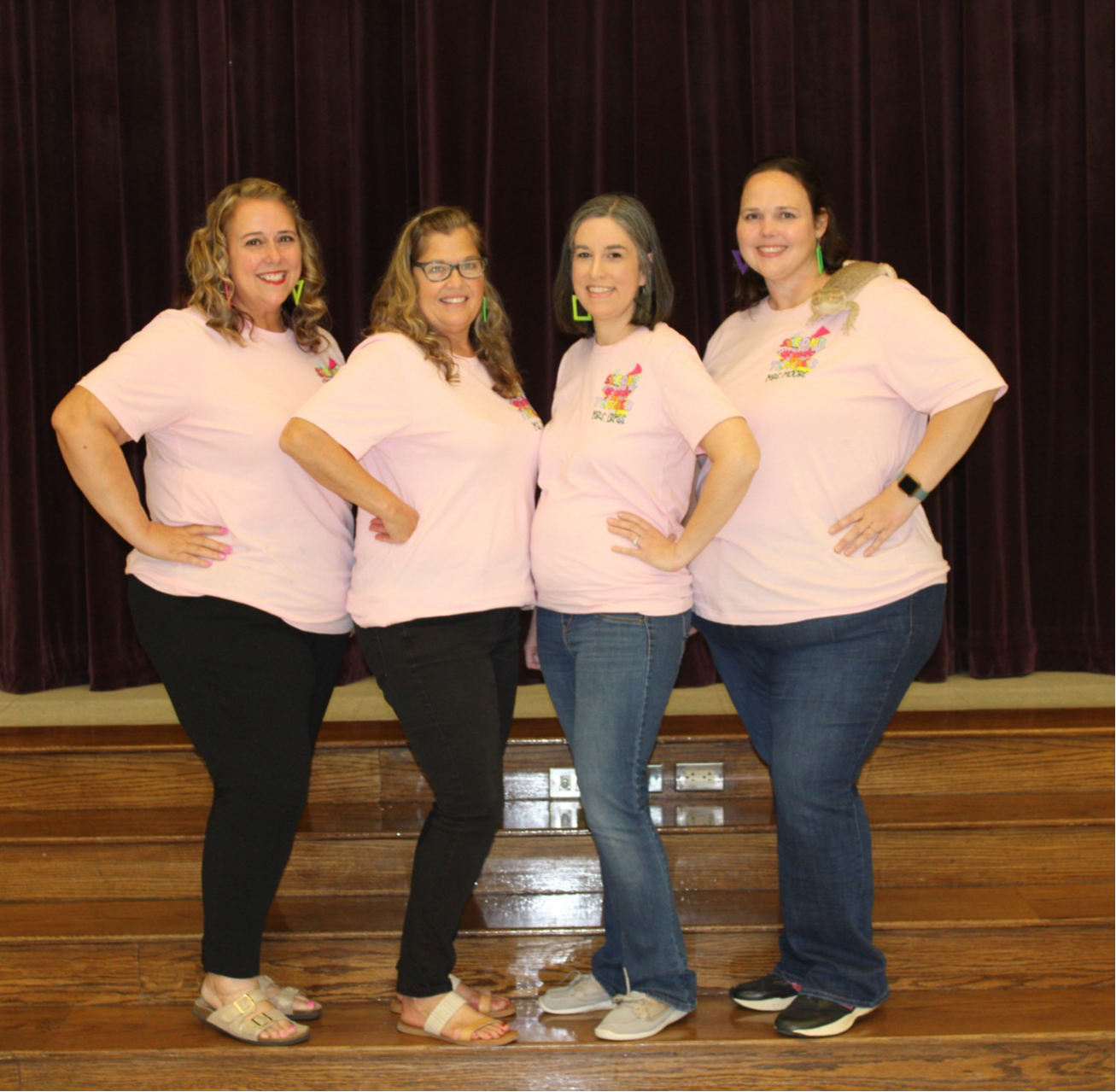 Second Grade team posing with stuffed bear on sofa