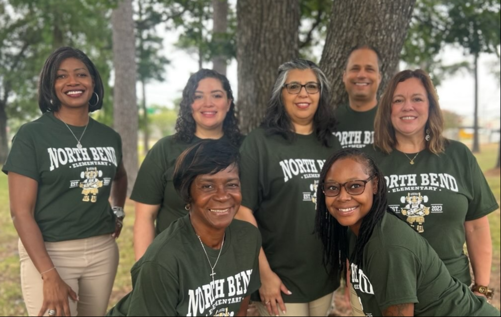 group of people in green shirts outside