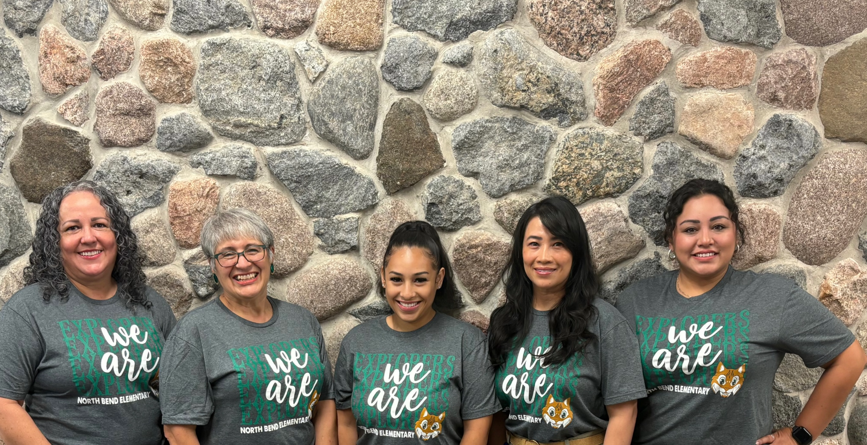 group posing in green shirts with decorative octopus