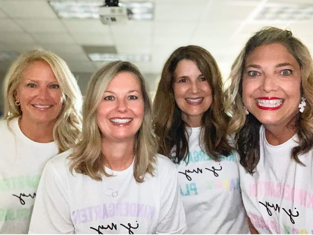 Kindergarten teachers posing in white shirts