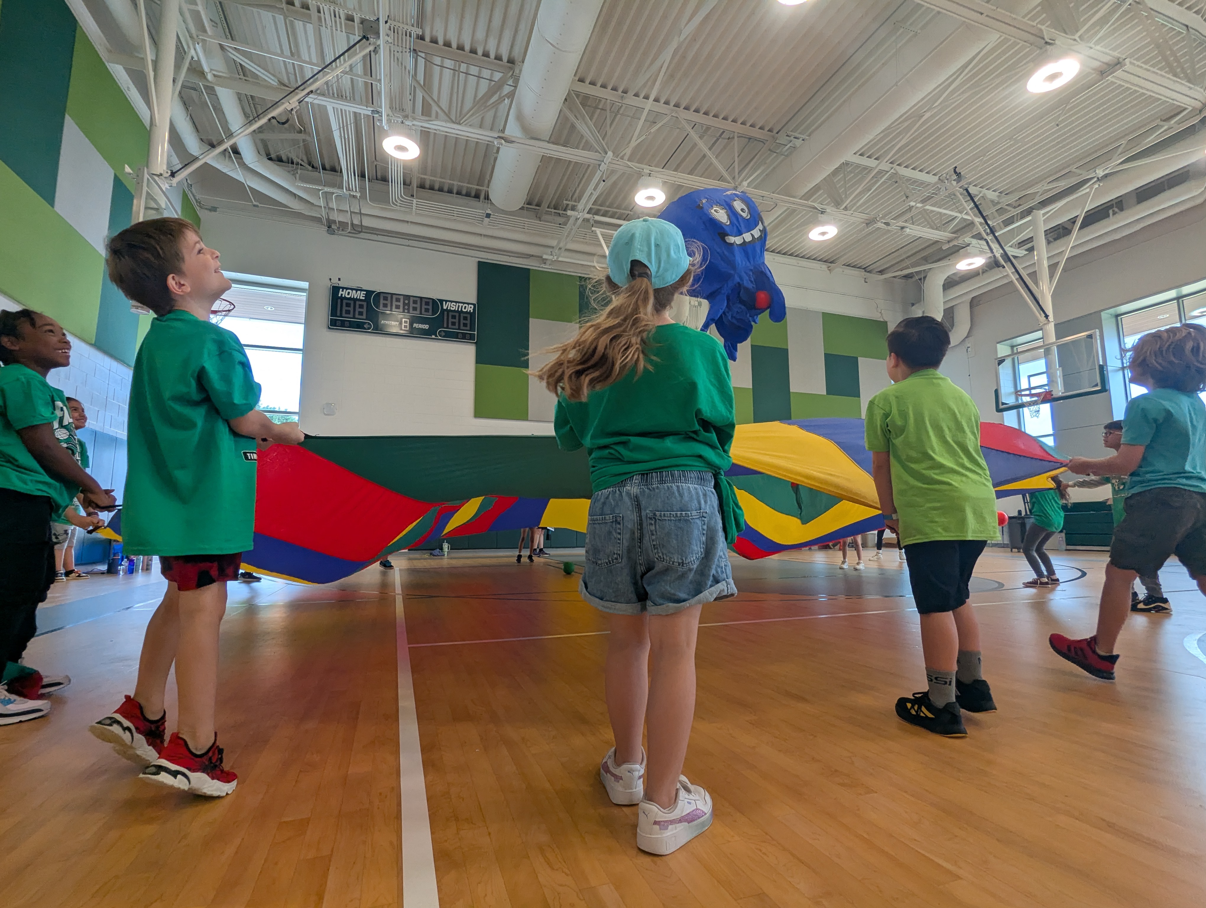 Students playing with a parachute at field day