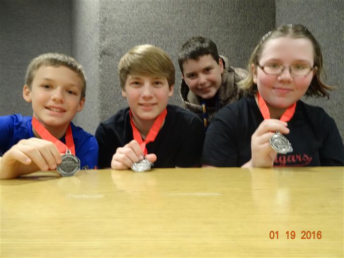 students holding up medals