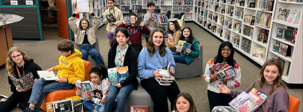 RMS students show off the chairs and books donated by the RMS PTO.