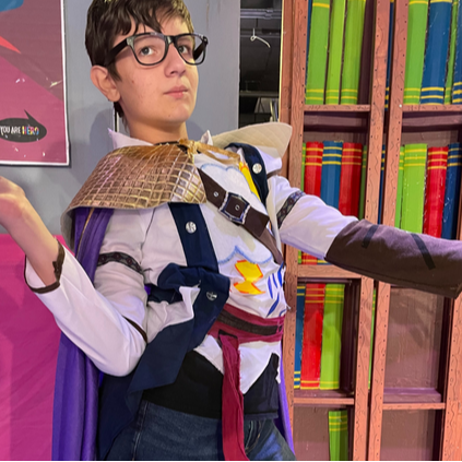 student in costume with glasses and cape