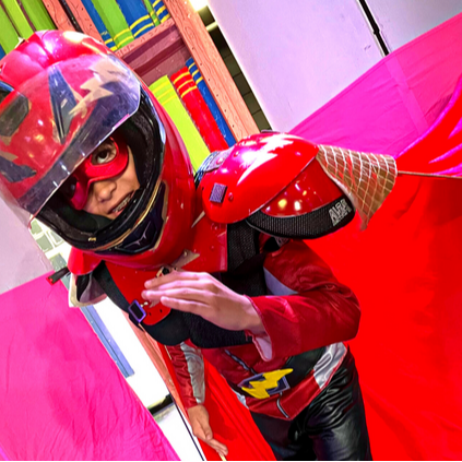 student in red costume with helmet