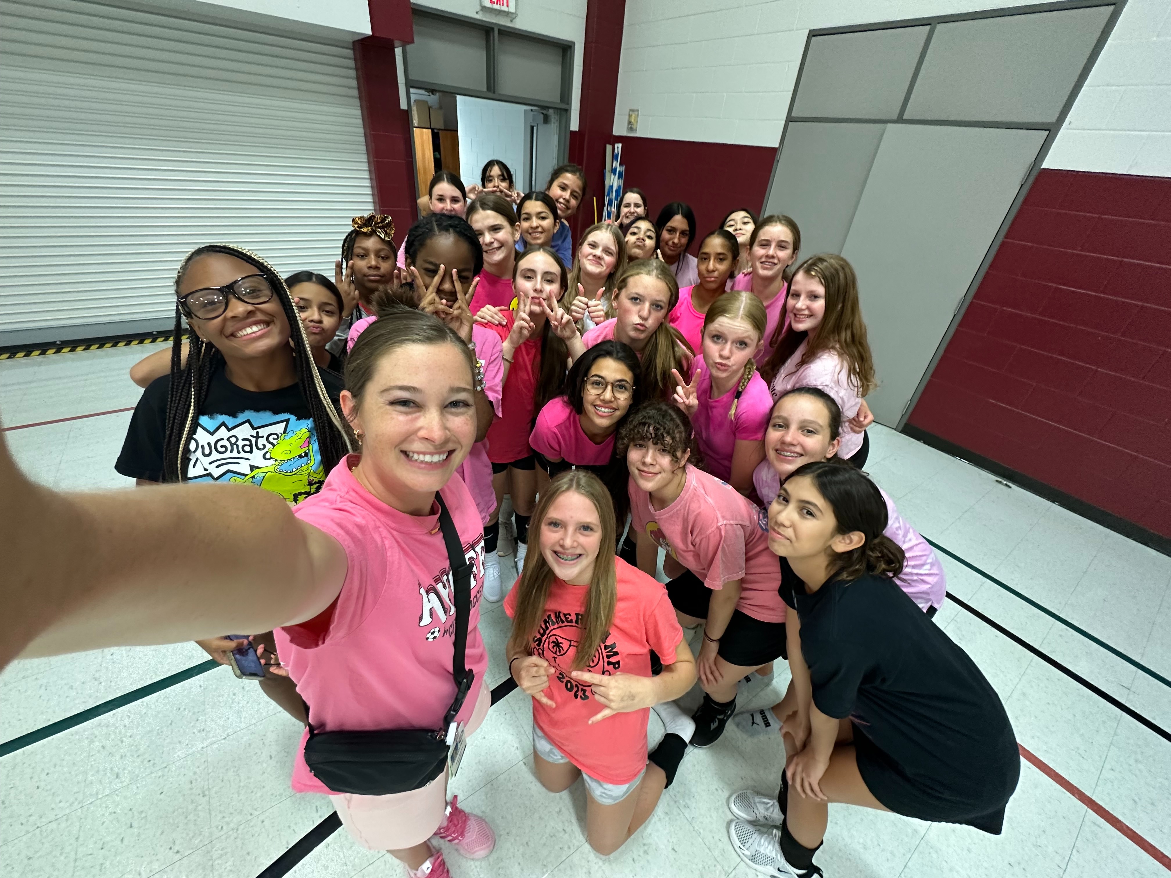 Group of Students posing in pink shirts