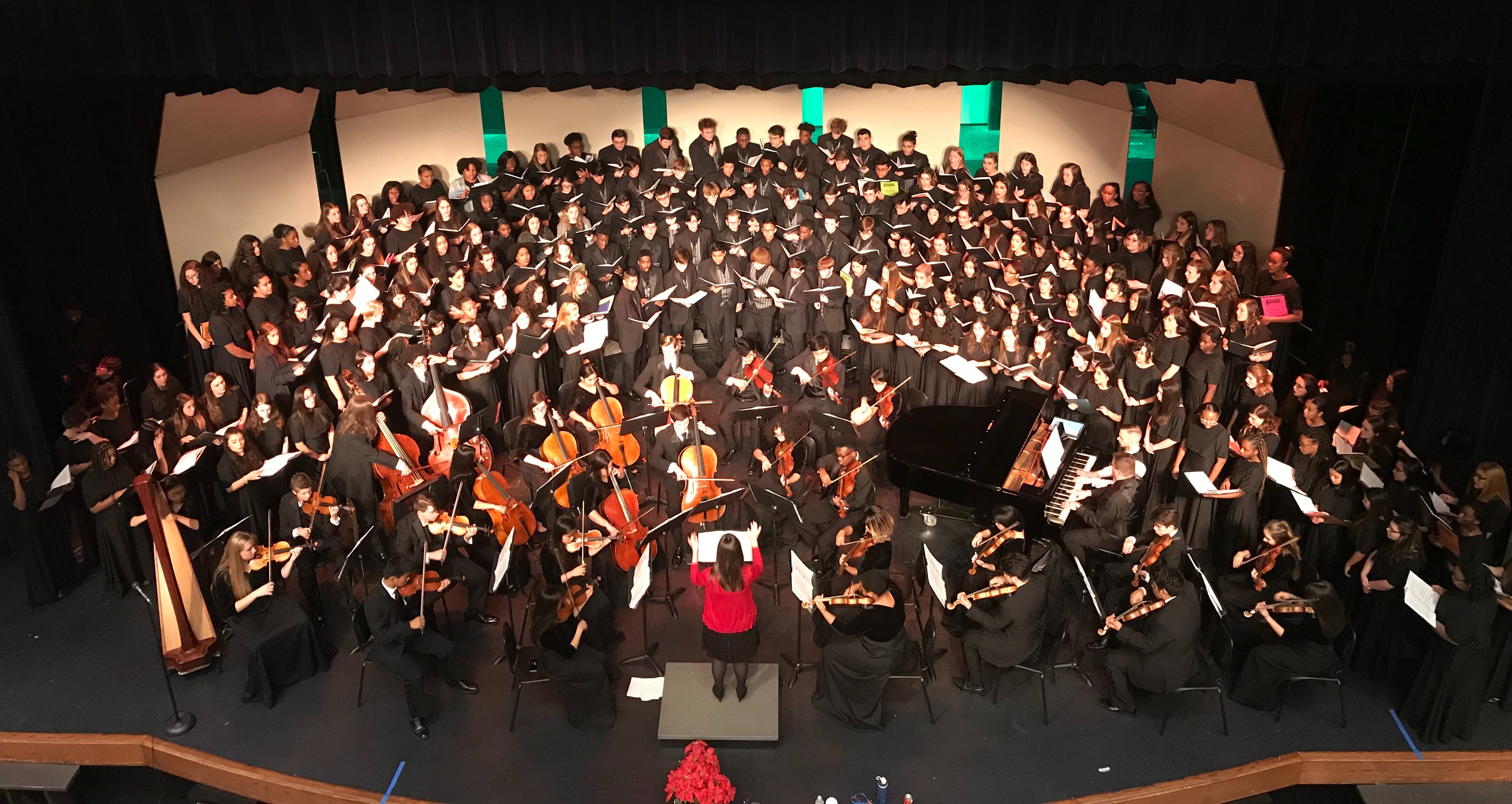 group of choir and orchestra students performing on stage