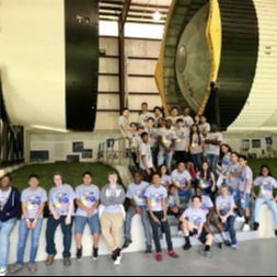 students pictured with rocket