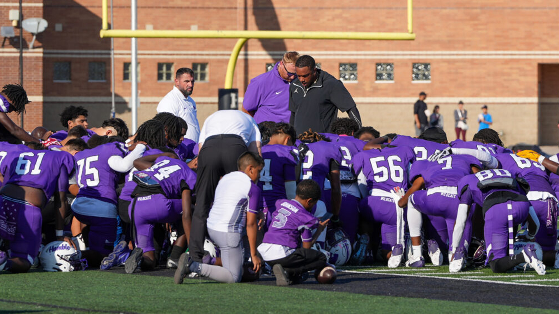 Football team huddle before Kingwood game.