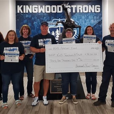 group standing posing with oversized check