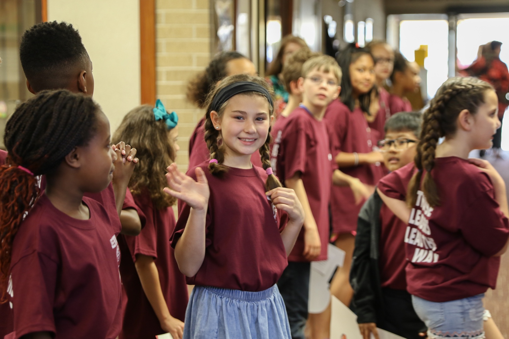 Students waving and looking at camera