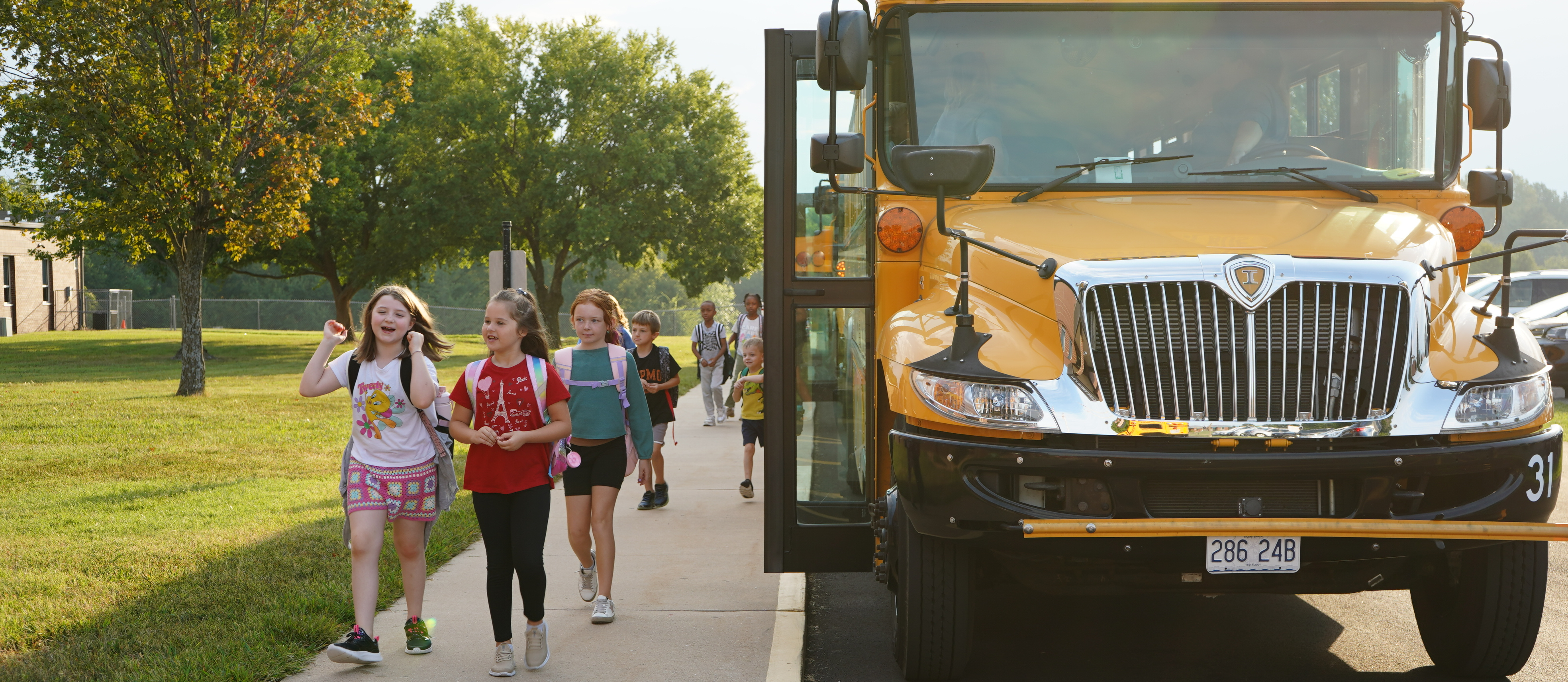 Students walking off school bus to school