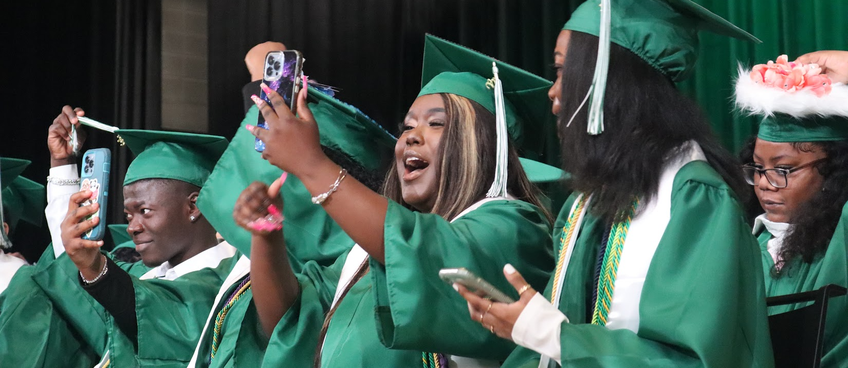 Weaver graduates taking selfie happy