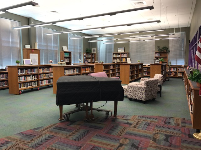 library shelves, books and piano