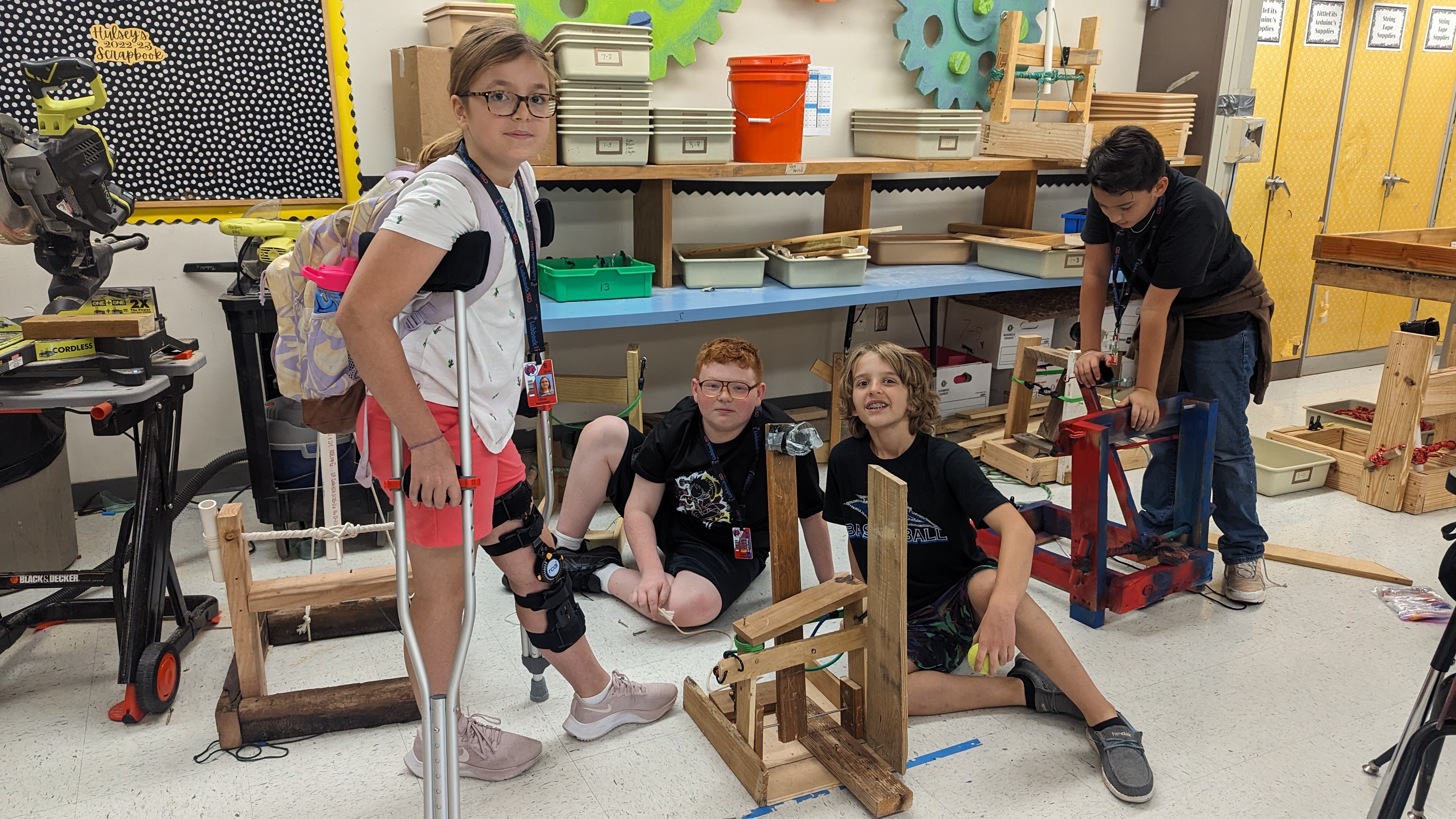 6th graders pose with their catapult