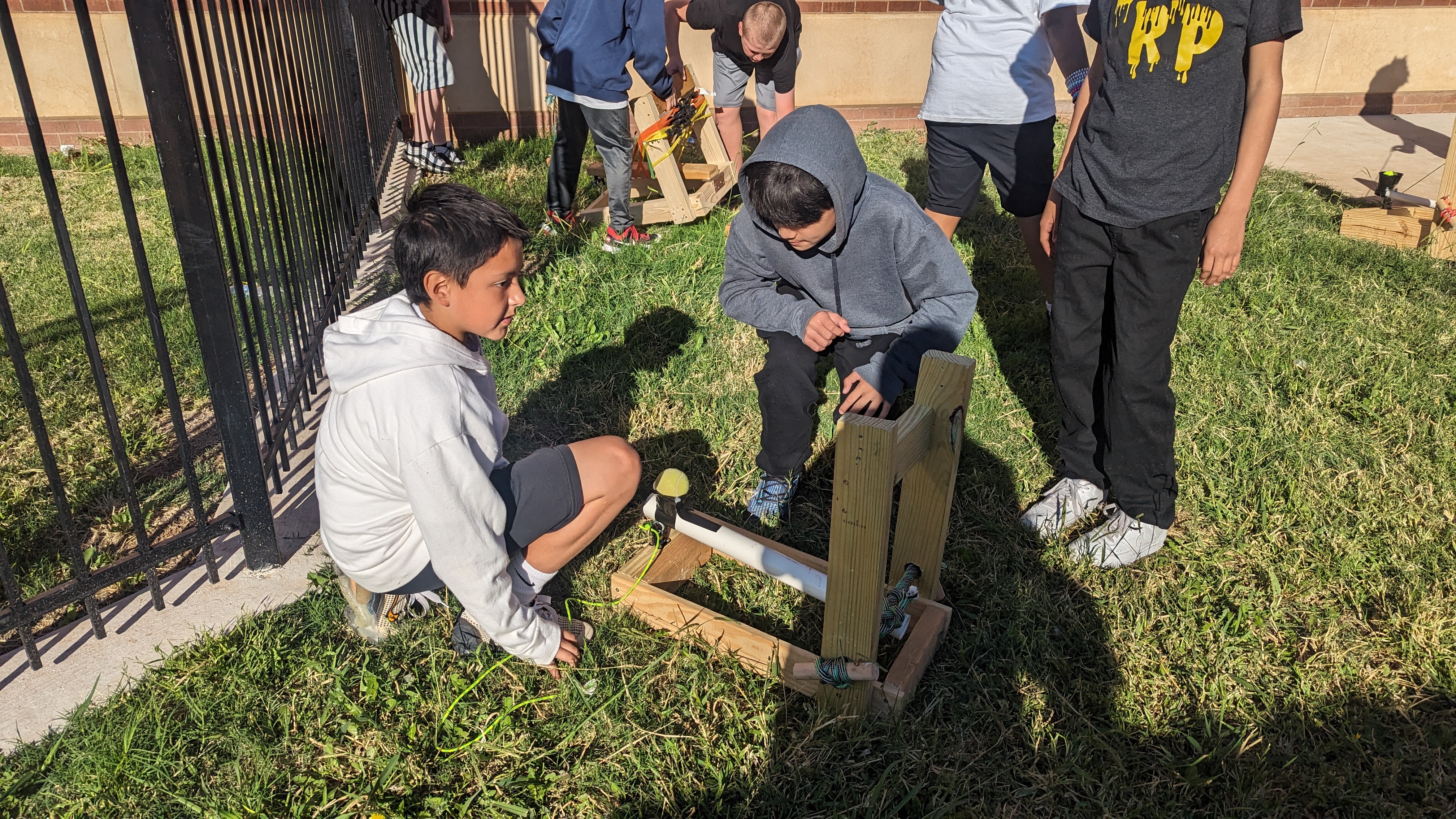 6th graders testing their catapults