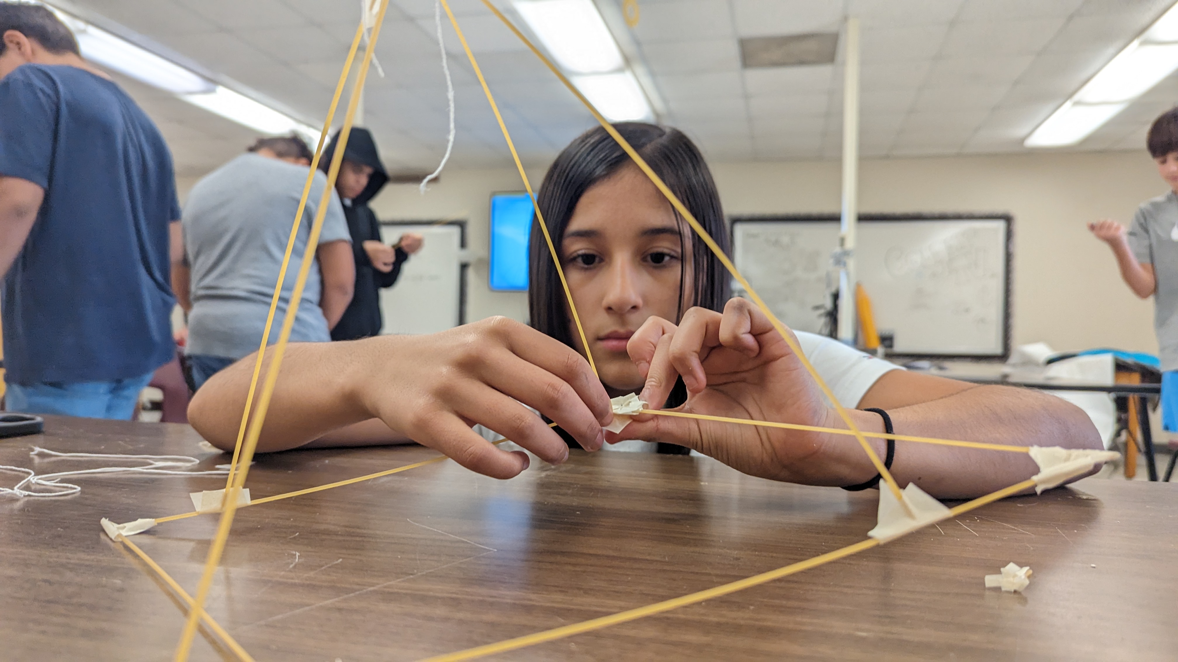 7th grader working on her marshmallow tower