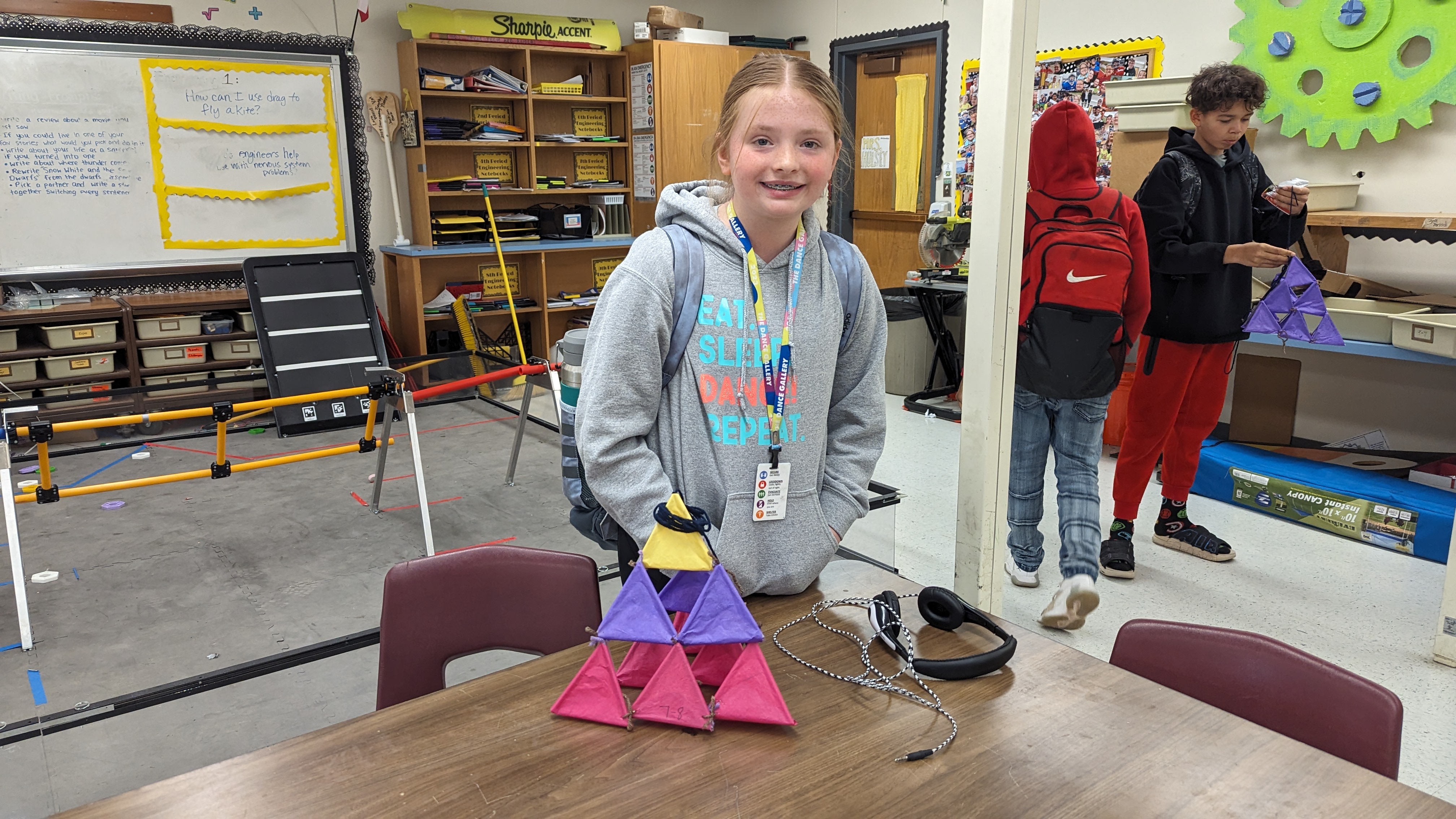 students pose with their completed tetrahedron kite