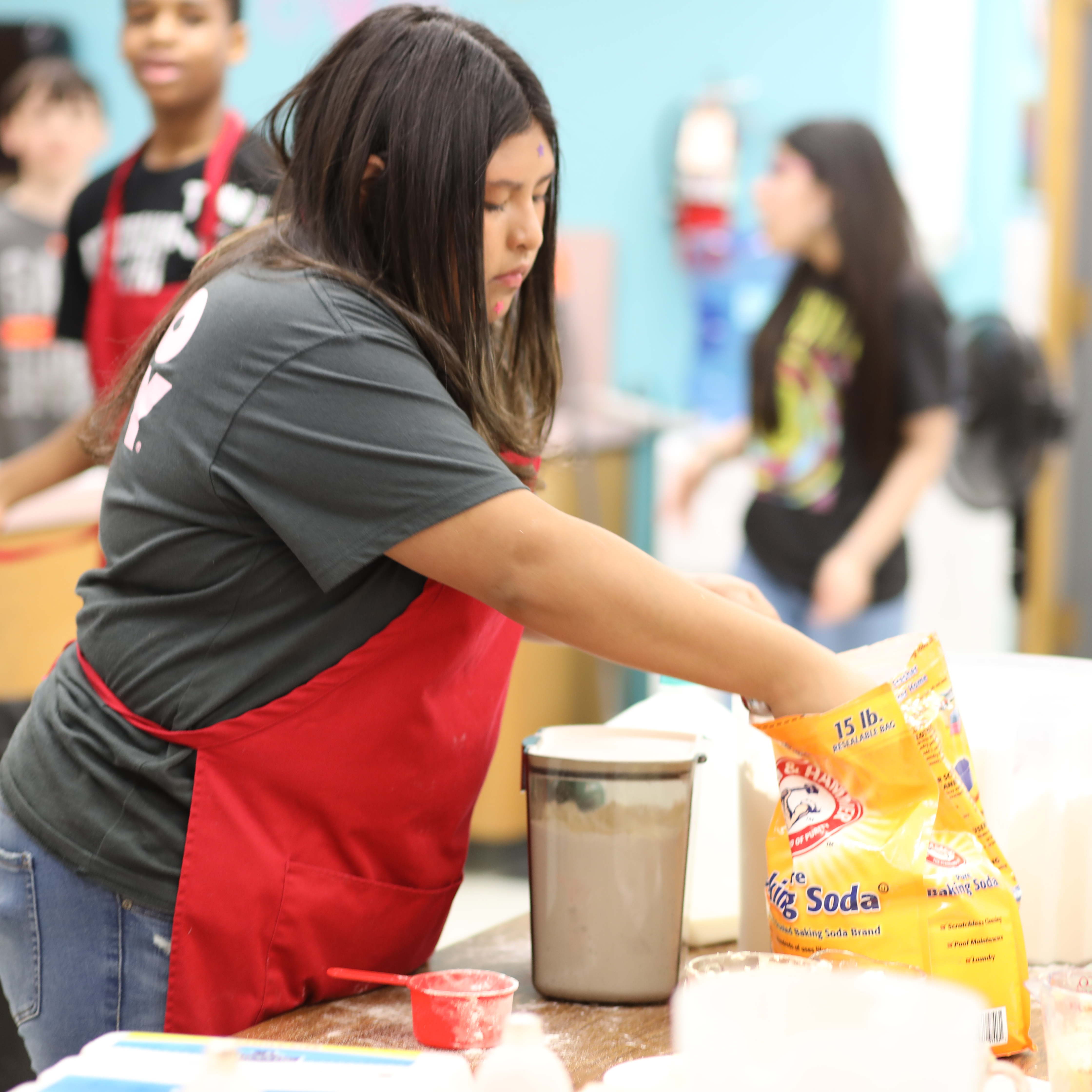 students getting ingredients for baking