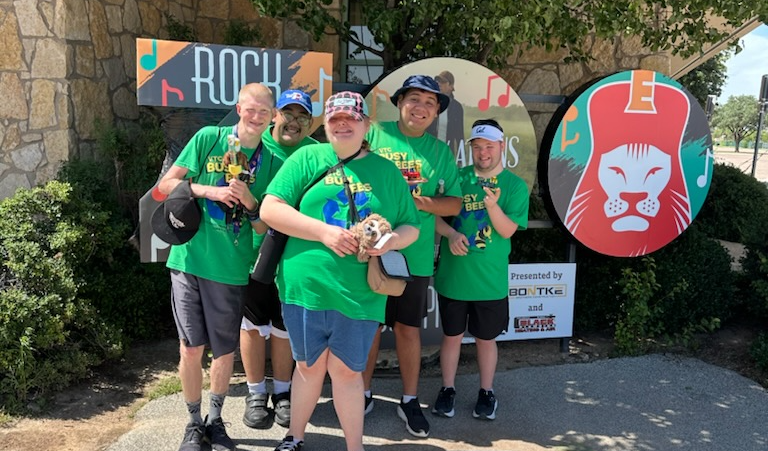 Troop 174 Scouts posing front of the Zoo sign at the Abilene Zoo